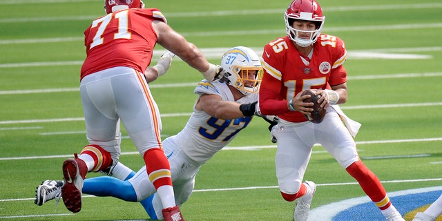 Kansas City Chiefs quarterback Patrick Mahomes, right, is tackled by Los Angeles Chargers defensive end Joey Bosa, center, during the second half of an NFL football game Sunday, Sept. 20, 2020, in Inglewood, Calif. (AP Photo/Kyusung Gong)