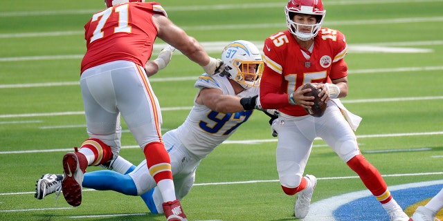 Kansas City Chiefs quarterback Patrick Mahomes, right, is tackled by Los Angeles Chargers defensive end Joey Bosa, center, during the second half of an NFL football game Sunday, Sept. 20, 2020, in Inglewood, Calif. (AP Photo/Kyusung Gong)