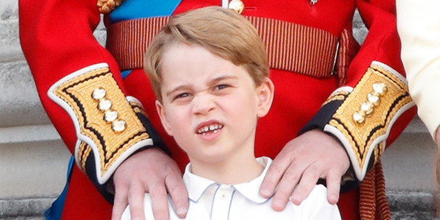 Prince George of Cambridge watches a flypast from the balcony of Buckingham Palace during Trooping The Colour