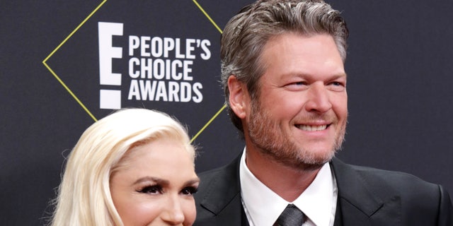 Gwen Stefani and Blake Shelton also exchanged 'I love yous' as they held up drinks and toasted to their big win. (Reuters)