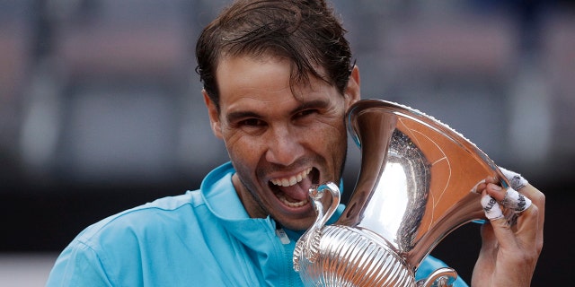 In this May 19, 2019 file photo, Rafael Nadal of Spain holds his trophy after winning against Novak Djokovic of Serbia at the end of their final match at the Italian Open tennis tournament, in Rome. (AP Photo/Gregorio Borgia)