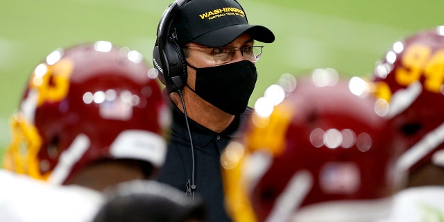 Washington Football Team head coach Ron Rivera talks with his players during the second half of an NFL football game against the Arizona Cardinals, Sunday, Sept. 20, 2020, in Glendale, Ariz. (AP Photo/Darryl Webb)