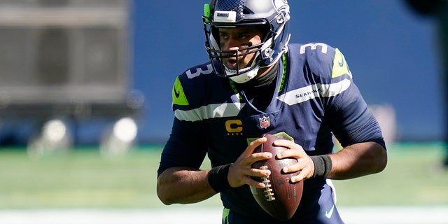 Seattle Seahawks quarterback Russell Wilson drops to pass against the Dallas Cowboys during the first half of an NFL football game, Sunday, Sept. 27, 2020, in Seattle. (AP Photo/Elaine Thompson)