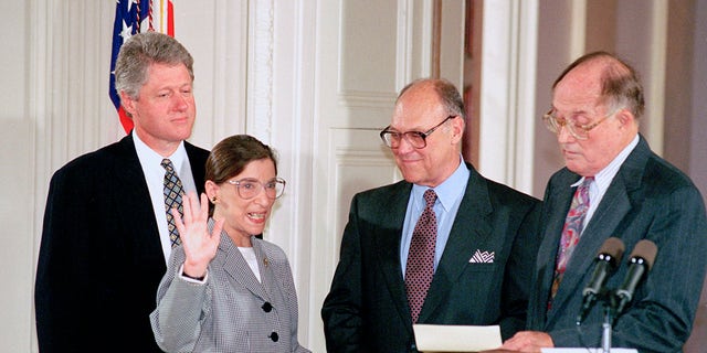 Supreme Court Justice Ruth Bader Ginsburg takes the court oath from Chief Justice William Rehnquist during a ceremony at the White House on Aug. 10, 1993. Ginsburg's husband Martin holds the Bible. (AP Photo/Marcy Nighswander, File)