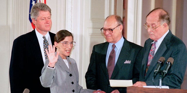 Supreme Court Justice Ruth Bader Ginsburg takes the court oath from Chief Justice William Rehnquist during a ceremony at the White House on Aug. 10, 1993. Ginsburg's husband Martin holds the Bible. (AP Photo/Marcy Nighswander, File)