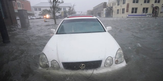 Floodwaters move on the street, Wednesday, Sept. 16, 2020, in Pensacola, Fla. as Hurricane Sally made landfall.