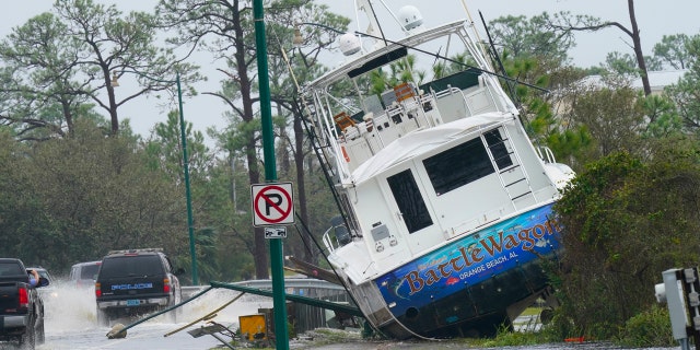 A boat is washed up near a road after Hurricane Sally moved through the area, Wednesday, Sept. 16, 2020, in Orange Beach, Ala.