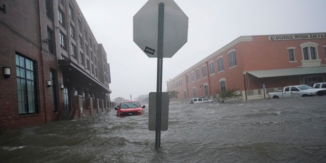 Floodwaters move on the street, Wednesday, Sept. 16, 2020, in Pensacola, Fla. Hurricane Sally made landfall Wednesday near Gulf Shores, Alabama, as a Category 2 storm, pushing a surge of ocean water onto the coast and dumping torrential rain.
