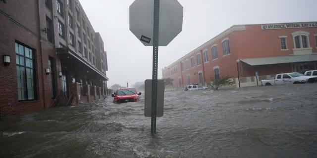 Floodwaters move on the street, Wednesday, Sept. 16, 2020, in Pensacola, Fla. Hurricane Sally made landfall Wednesday near Gulf Shores, Ala., as a Category 2 storm, pushing a surge of ocean water onto the coast and dumping torrential rain.