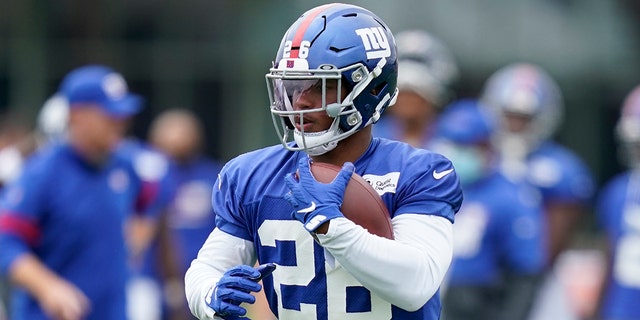 New York Giants' Saquon Barkley runs the ball during practice at the NFL football team's training camp in East Rutherford, N.J., Wednesday, Aug. 19, 2020. (AP Photo/Seth Wenig)
