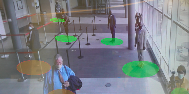 A social-distancing machine monitors if students are too close together.