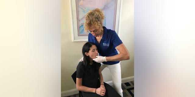 Physical Therapist demonstrates a technique to address jaw pain due to tight muscles in neck and jaw area. TMJ/TMD pain is a symptom being seen in COVID patients who were "mouth breathers", some health professionals told Fox News.