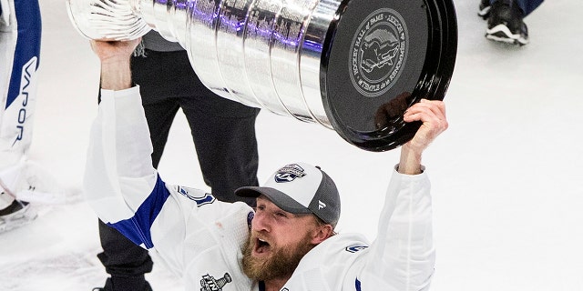 Tampa Bay Lightning center Steven Stamkos (91) hoists the Stanley Cup after defeating the Dallas Stars in Edmonton, Alberta, on Monday, Sept. 28, 2020. (Jason Franson/The Canadian Press via AP)