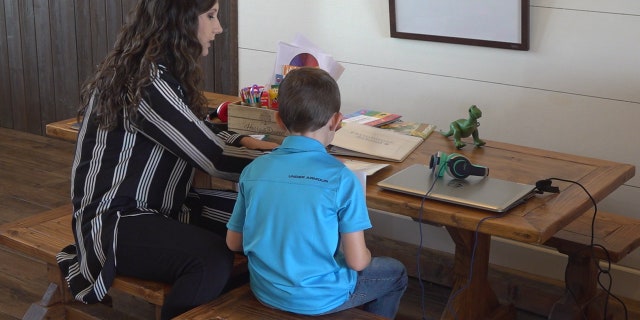 Teacher Madison Harris stops by the farm's schoolhouse twice a week to help with homework, classwork, and Spanish to English translation (Stephanie Bennett/Fox News).