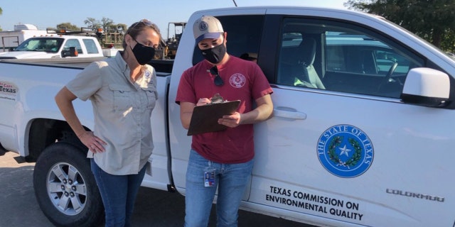 Investigators from the Texas Commission on Environmental Quality conduct water sampling in Lake Jackson, Texas on Sept. 26, 2020 after a brain-eating amoeba was detected in the city's water supply.