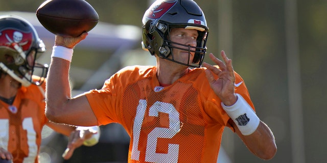 In this Aug. 24, 2020, file photo, Tampa Bay Buccaneers quarterback Tom Brady (12) and quarterback Blaine Gabbert (11) throw passes during an NFL football training camp practice in Tampa, Fla.(AP Photo/Chris O'Meara, File)