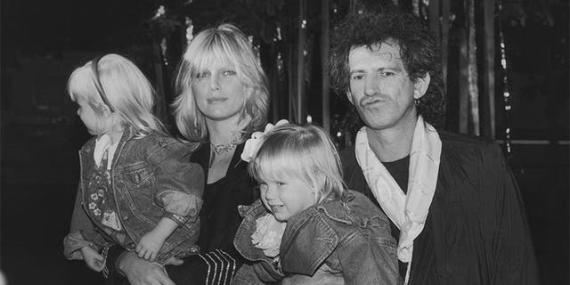 Guitarist Keith Richards of the Rolling Stones arrives at the Big Apple Circus at the Lincoln Center's Damrosch Park with his wife Patti and their daughters Theodora and Alexandra, November 1988.