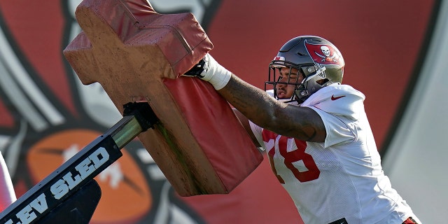 Tampa Bay Buccaneers 2020 first-round draft pick offensive tackle Tristan Wirfs works against a blocking sled during an NFL football training camp practice Monday, Aug. 24, 2020, in Tampa, Fla. (AP Photo/Chris O'Meara)