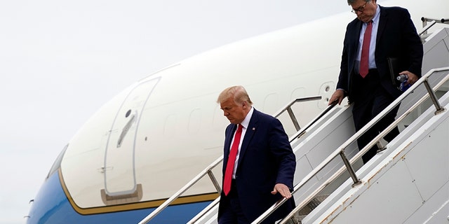 President Trump arrives on Air Force One, followed by Attorney General William Barr as he arrives at Waukegan National Airport in Waukegan, Ill., Sept. 1, 2020, in Kenosha. (AP Photo/Evan Vucci)