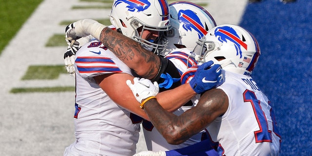 Buffalo Bills' Tyler Kroft, left, celebrates with teammates after catching a pass for a touchdown during the second half of an NFL football game against the Los Angeles Rams Sunday, Aug. 26, 2018, in Orchard Park, N.Y. The Bills won 35-32. (AP Photo/Adrian Kraus)