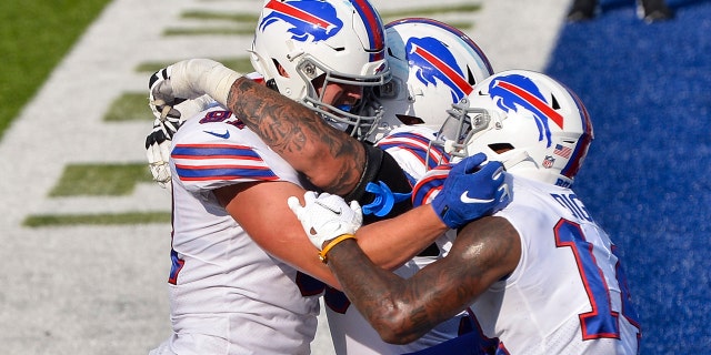 Buffalo Bills' Tyler Kroft, links, celebrates with teammates after catching a pass for a touchdown during the second half of an NFL football game against the Los Angeles Rams Sunday, Aug.. 26, 2018, in Orchard Park, N.Y.. The Bills won 35-32. (AP Photo/Adrian Kraus)