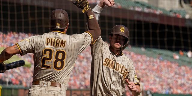 San Diego Padres' Wil Myers is greeted by teammate Tommy Pham (28) after hitting a home run off San Francisco Giants starting pitcher Drew Smyly in the second inning of a baseball game Sunday, Sept.. 27, 2020, in San Francisco. (AP Photo/Eric Risberg)
