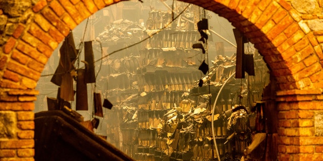 Charred wine bottles rest at Castello di Amorosa, Monday, Sept. 28, 2020, in Calistoga, Calif., which was damaged in the Glass Fire.