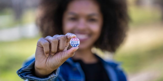 On Election Day in November, women will determine control in Washington 2 A woman holding a voting badge. iStock