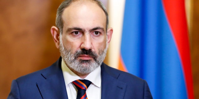 Armenian Prime Minister Nikol Pashinian pauses as he speaks at the Armenian parliament in Yerevan, Armenia, Sunday, Sept. 27, 2020.