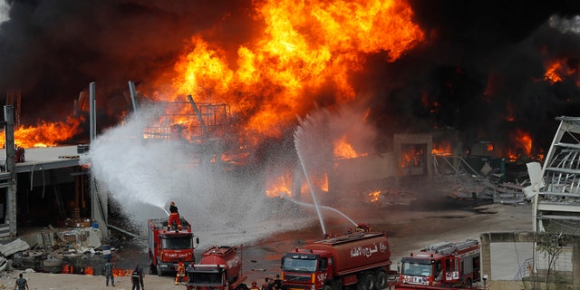 Fire burns in the port in Beirut, Lebanon, Thursday, Sept. 10. 2020. A huge fire broke out Thursday at the Port of Beirut, triggering panic among residents traumatized by last month's massive explosion that killed and injured thousands of people. (AP Photo/Hussein Malla)