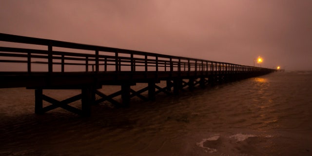 Waves crash against the pier at Kingfisher Park in Port O'Connor, Texas, as Tropical Storm Beta moved into the area Monday, Sept. 21, 2020.