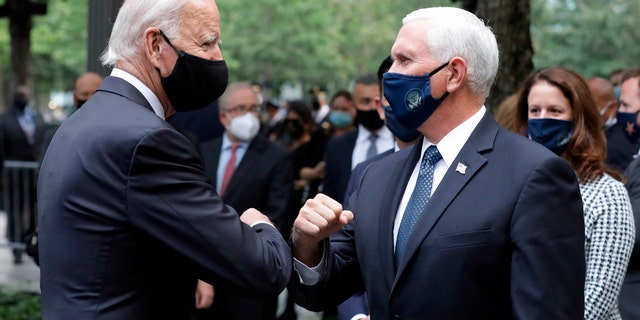 Democratic presidential candidate former Vice President Joe Biden greets Vice President Mike Pence at the 19th anniversary ceremony in observance of the Sept. 11 terrorist attacks at the National September 11 Memorial & Museum in New York, on Friday, Sept. 11, 2020. (Amr Alfiky/The New York Times via AP, Pool)