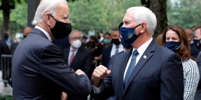 Democratic presidential candidate former Vice President Joe Biden greets Vice President Mike Pence at the 19th anniversary ceremony in observance of the Sept. 11 terrorist attacks at the National September 11 Memorial & Museum in New York, on Friday, Sept. 11, 2020. (Amr Alfiky/The New York Times via AP, Pool)