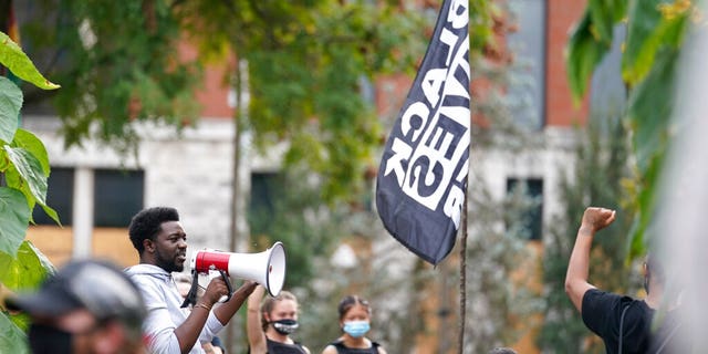 A man speaks to Black Lives Matter protesters, Friday, Sept. 25, 2020, in Louisville. (AP Photo/Darron Cummings)