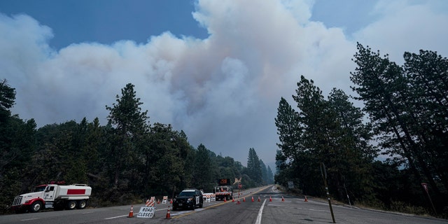 Smoke from the Creek Fire billows in the sky at a road closure Monday, Sept. 7, 2020, in Shaver Lake, Calif.