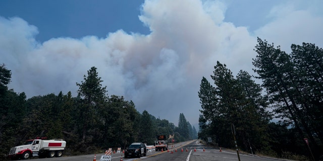 Smoke from the Creek Fire billows in the sky at a road closure Monday, Sept. 7, 2020, in Shaver Lake, Calif.