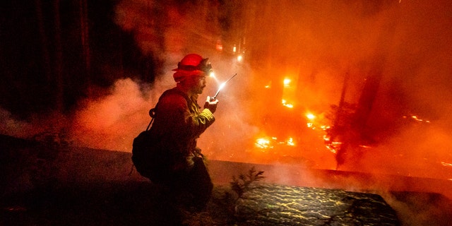 A firefighter battles the Creek fire in the Shaver Lake community of Fresno County, California, Monday, Sept. 7, 2020.