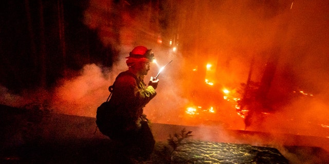 A firefighter battles the Creek Fire in the Shaver Lake community of Fresno County, Calif., on Monday, Sept. 7, 2020.