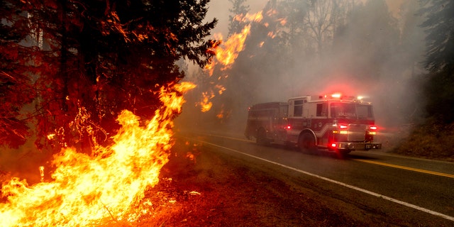A firetruck drives along state Highway 168 while battling the Creek Fire in the Shaver Lake community of Fresno County, Calif., on Monday, Sept. 7, 2020.