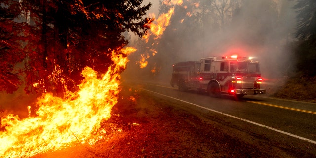 A firetruck drives along state Highway 168 while battling the Creek Fire in the Shaver Lake community of Fresno County, Calif., on Monday, Sept. 7, 2020.