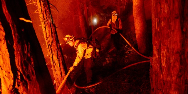 Firefighter Nick Grinstead battles the Creek Fire in the Shaver Lake community of Fresno County, Calif., on Monday, Sept. 7, 2020.