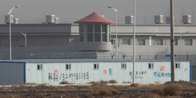 In this 2018 photo, a guard tower and barbed wire fences are seen around a facility in the Kunshan Industrial Park in Artux in western China's Xinjiang region. An Australian think tank says China appears to be expanding its network of secret detention centers in Xinjiang, where Muslim minorities are targeted in a forced assimilation campaign. (AP)