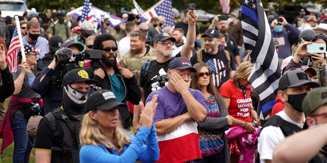 Members of the Proud Boys and other right-wing demonstrators rally, Saturday, Sept. 26, 2020, in Portland, Ore. (AP Photo/Allison Dinner)