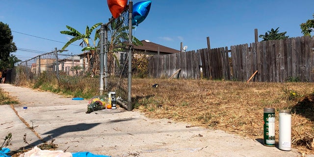 Balloons, candles and flowers are left on Tuesday as a memorial for Dijon Kizzee where he was fatally shot by Los Angeles sheriff's deputies the day before in the Westmont section of Los Angeles. (AP Photo/Stefanie Dazio)