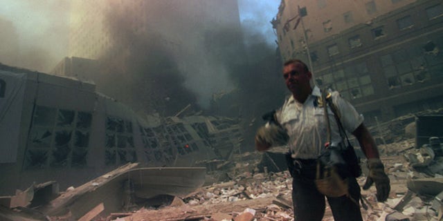 A New York rescue worker amid the rubble of the World Trade Center following the 9/11 attacks. (Photo by: Universal History Archive/Universal Images Group via Getty Images)<br>