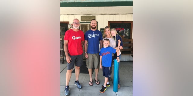 The Gillett family in front of Cressman's General Store with its previous owner Keith Davis.