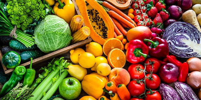 Many fruits and vegetables are shown.  The American Heart Association suggests that fruits and vegetables should fill half of the plate for each meal. 