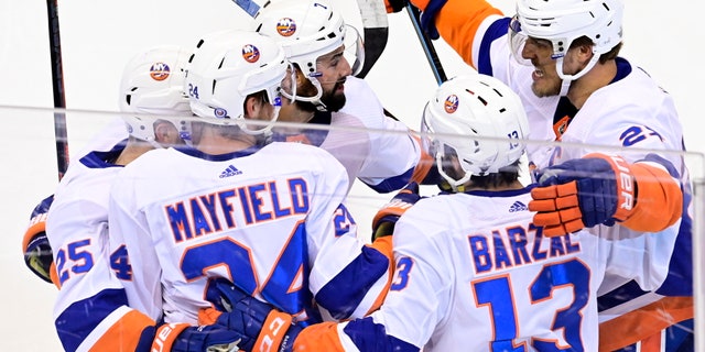 New York Islanders defenseman Scott Mayfield (24) celebrates his goal against the Philadelphia Flyers with teammates during first-period NHL Stanley Cup Eastern Conference playoff hockey game action in Toronto, Saturday, Sept. 5, 2020. (Frank Gunn/The Canadian Press via AP)