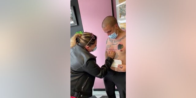 Bruno Neves. from Great Yarmouth, U.K., popped the question to his girlfriend Patricia Calado with a tattoo that read "Will you marry me?" (SWNS)