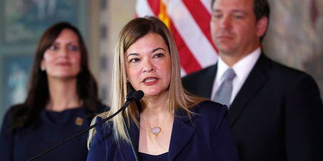 Judge Barbara Lagoa, center, speaks as Florida Gov. Ron DeSantis and Lt. Gov Jeanette Nunez, left, look on, Jan. 9, 2019, in Miami. (Associated Press)